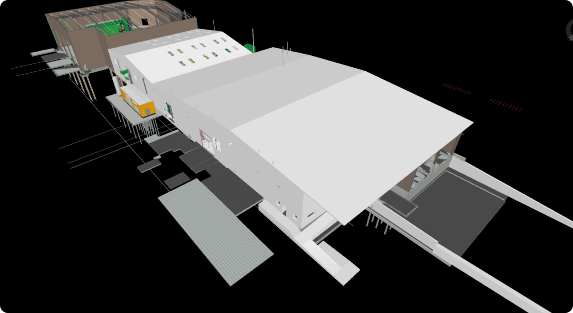 Fortune 100 Waste Management Account: 40+ MRF Retrofits Documented Since Introducing 3D Laser Scanning 7 3D BIM model aerial perspective of an industrial facility, showing its angular roof sections, exterior walls, and support structures rendered in neutral tones against a black background.