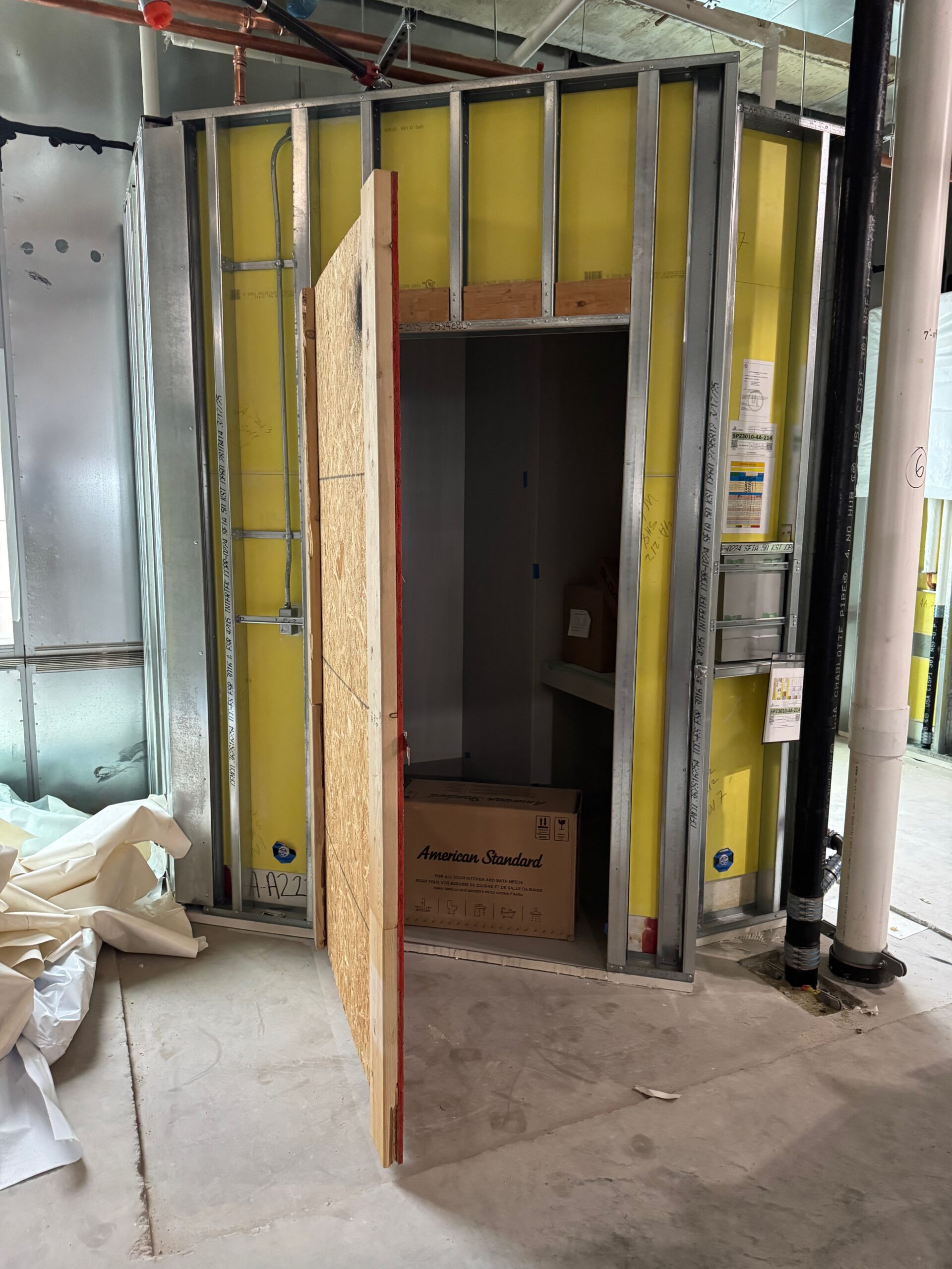 Open construction elevator shaft with door